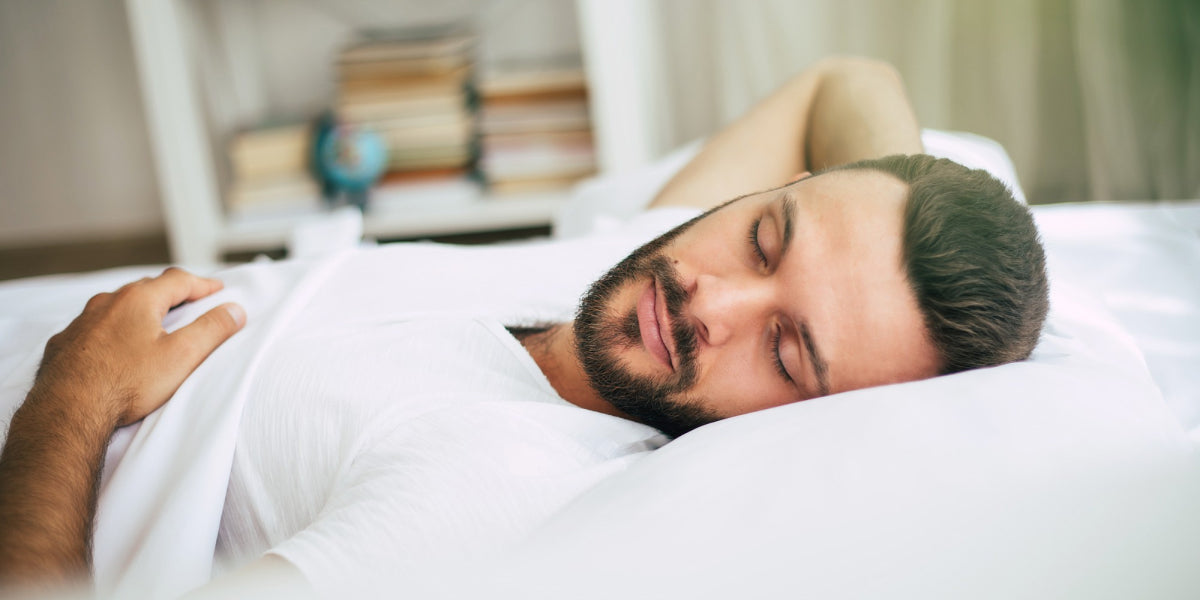 A bearded man sleeping comfortably.