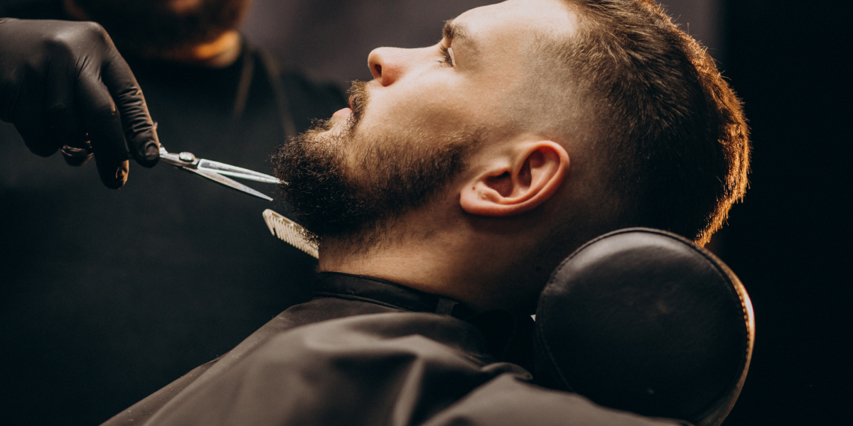 A man with beard getting a trim