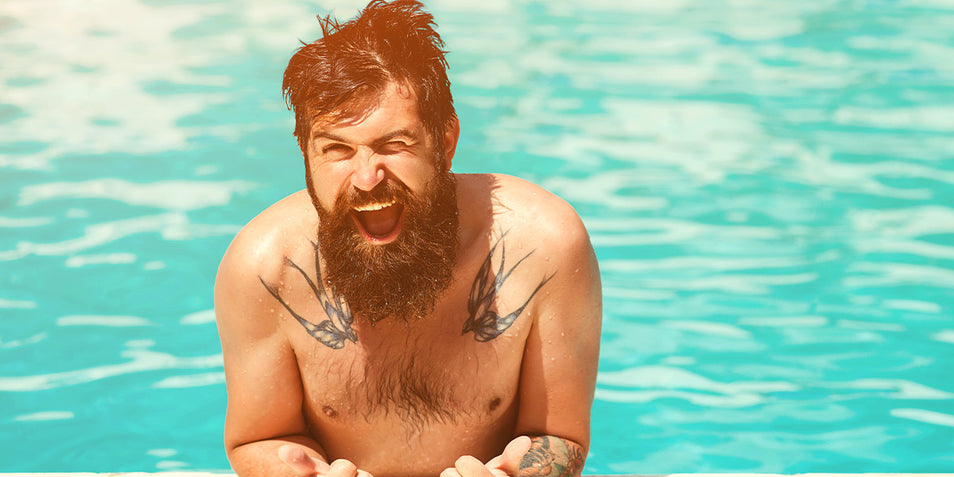 A bearded man enjoying in the pool.