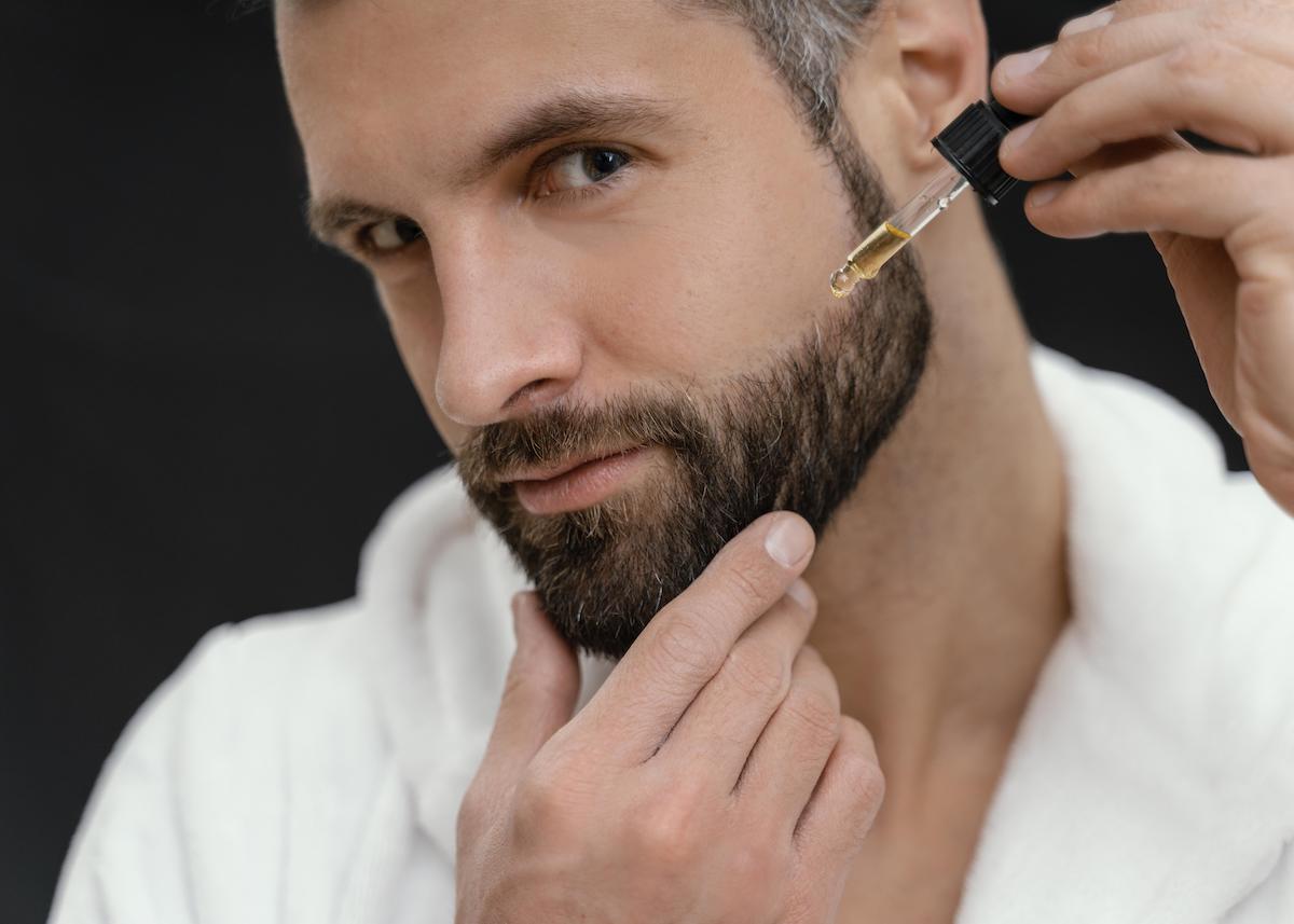 man applying beard oil everyday